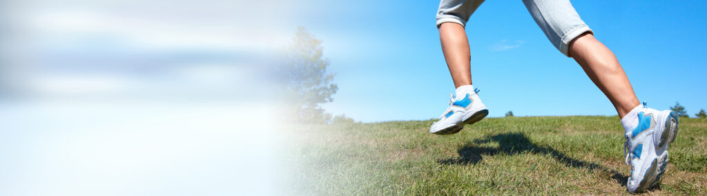 Young healthy woman jogging in summer beautiful park